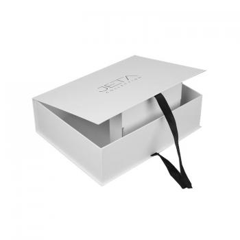 White book style box with ribbon